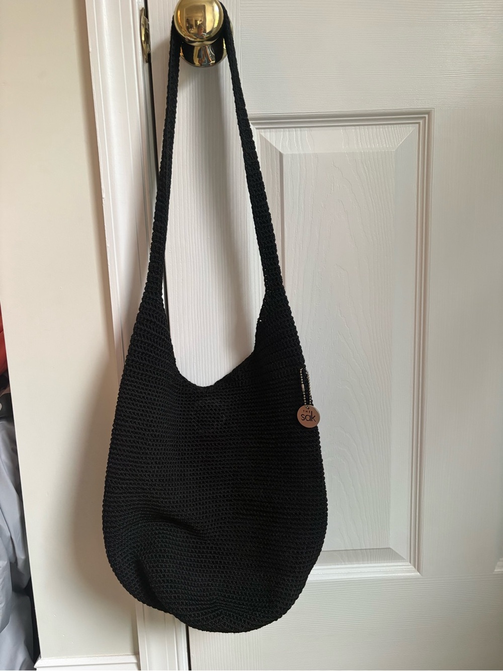 The Sak Black Crochet Shoulder Bag with Branded Charm